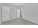 A large empty bedroom featuring neutral-colored walls, carpeted floors and two closets at 3313 Brunot St, New Hill, NC 27562
