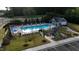 View of a beautiful community pool with patio tables and chairs and a playground at Betterra, Clayton, NC at 3313 Brunot St, New Hill, NC 27562