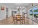 Bright dining area with hardwood floors, a patio view, and a modern chandelier at 3313 Brunot St, New Hill, NC 27562