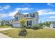Two-story home featuring a light gray exterior, black shutters, and a two-car garage with a well-manicured lawn at 3313 Brunot St, New Hill, NC 27562