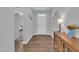 Inviting foyer featuring hardwood floors, neutral walls, decorative lighting, and a white front door at 3313 Brunot St, New Hill, NC 27562