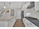 Modern kitchen features granite counters, stainless steel appliances, and hardwood floors at 3313 Brunot St, New Hill, NC 27562