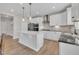 Well-lit kitchen with a spacious island, modern appliances, and white cabinetry at 3313 Brunot St, New Hill, NC 27562