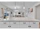 An island counter extends into a spacious living area with modern lighting and an open floor plan at 3313 Brunot St, New Hill, NC 27562