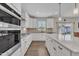 Modern kitchen with white cabinets, stainless steel appliances, and granite countertops at 3313 Brunot St, New Hill, NC 27562