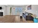 Bright living room featuring hardwood floors, neutral walls, a fireplace, and ample natural light from the large windows at 3313 Brunot St, New Hill, NC 27562