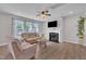Comfortable living room with a fireplace, ceiling fan, and plenty of natural light at 3313 Brunot St, New Hill, NC 27562