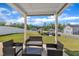 Inviting covered patio with comfortable seating and a picturesque view of the manicured lawn at 3313 Brunot St, New Hill, NC 27562