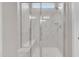 Walk-in shower with glass doors, a built-in bench and a rainfall shower head at 3313 Brunot St, New Hill, NC 27562