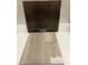Interior material selection with a dark cabinet door and Shaw luxury vinyl flooring in Lighthouse color at 351 Chesapeake Cmns St # 111, Garner, NC 27529