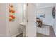 Powder room featuring a pedestal sink and decorative artwork, leading to another room with neutral decor at 366 Bunker Hill Place, Angier, NC 27501