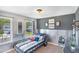 Unique bedroom with car-themed decor, modern lighting, and large windows offering natural light at 366 Bunker Hill Place, Angier, NC 27501