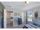 Unique bedroom with metal-look panels, modern light fixtures, and view into an adjoining room at 366 Bunker Hill Place, Angier, NC 27501