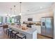 Open kitchen featuring a large island with seating, stainless steel appliances, and white cabinetry at 366 Bunker Hill Place, Angier, NC 27501