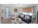 Inviting living room featuring a cozy sofa, accent chair, and natural light from a window with blinds at 366 Bunker Hill Place, Angier, NC 27501
