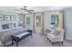 Bright main bedroom with large windows, a cozy seating area, and a comfortable upholstered bed at 366 Bunker Hill Place, Angier, NC 27501