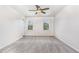 Spacious carpeted bedroom illuminated by natural light and equipped with a ceiling fan at 3713 Phillips W Way, Durham, NC 27713