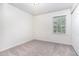 Bedroom features neutral carpet, a window with natural light, and a closet for storage at 3713 Phillips W Way, Durham, NC 27713