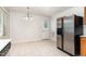 Open Kitchen that includes stainless steel refrigerator, tile flooring, and an adjacent dining area at 3713 Phillips W Way, Durham, NC 27713