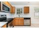 Kitchen features stainless steel appliances, oak cabinets, and bright countertops, creating a functional cooking area at 3713 Phillips W Way, Durham, NC 27713