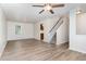 Open living room with ceiling fan, fresh paint, hardwood floors and easy access to staircase and kitchen at 3713 Phillips W Way, Durham, NC 27713
