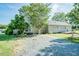Rear view of a house featuring an outdoor living area, patio, and lakeside access at 3714 Mt Zion Church Rd, Mebane, NC 27302