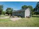 Back of the house featuring a small deck, patio, well-maintained lawn, and mature trees at 3714 Mt Zion Church Rd, Mebane, NC 27302