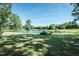 Lush backyard with a tranquil pond and plenty of mature trees offering shade and privacy at 3714 Mt Zion Church Rd, Mebane, NC 27302