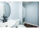 Bathroom featuring a toilet, sink, shower with curtain, black fixtures, and hardwood floor at 3714 Mt Zion Church Rd, Mebane, NC 27302