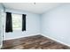 Bedroom featuring wood flooring and a window with dark curtains at 3714 Mt Zion Church Rd, Mebane, NC 27302