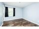 Bedroom featuring wood flooring and a window with dark curtains at 3714 Mt Zion Church Rd, Mebane, NC 27302