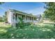 A cozy home with a covered front porch, mature trees, and a green lawn at 3714 Mt Zion Church Rd, Mebane, NC 27302