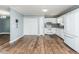 Bright kitchen features white cabinets, appliances, and subway tile backsplash paired with wood floors at 3714 Mt Zion Church Rd, Mebane, NC 27302