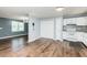 Bright kitchen features white cabinets, appliances, and subway tile backsplash paired with wood floors at 3714 Mt Zion Church Rd, Mebane, NC 27302