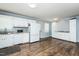 Bright kitchen features white cabinets, appliances, and subway tile backsplash paired with wood floors at 3714 Mt Zion Church Rd, Mebane, NC 27302