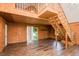 Spacious living room with hardwood floors, wood walls, staircase to upper level, and a large window at 3714 Mt Zion Church Rd, Mebane, NC 27302