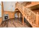 Spacious living room with hardwood floors, fireplace, staircase to upper level, and chandelier at 3714 Mt Zion Church Rd, Mebane, NC 27302