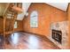 Spacious living room featuring wood walls, a fireplace, large windows and a staircase to a second level at 3714 Mt Zion Church Rd, Mebane, NC 27302