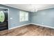 A well-lit room showcasing natural light, freshly painted walls, and sleek hardwood floors at 3714 Mt Zion Church Rd, Mebane, NC 27302