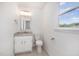 Bathroom features a white vanity, granite countertop, new fixtures, and a window for natural light at 40 Crepe Myrtle Ct, Angier, NC 27501