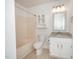 Bright bathroom with white cabinets, granite countertop, tub, and shower combo at 40 Crepe Myrtle Ct, Angier, NC 27501
