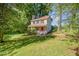 Two-story home surrounded by mature trees and lush green lawn at 40 Crepe Myrtle Ct, Angier, NC 27501