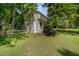 Charming two-story home with a welcoming front porch nestled amongst mature trees and lush green surroundings at 40 Crepe Myrtle Ct, Angier, NC 27501
