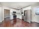 Well-lit kitchen features stainless steel appliances, white cabinets, hardwood floors, and neutral backsplash at 40 Crepe Myrtle Ct, Angier, NC 27501