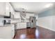 Charming kitchen featuring white cabinets, stainless steel appliances, granite countertops, and hardwood floors at 40 Crepe Myrtle Ct, Angier, NC 27501