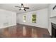 Bright living room has hardwood floors, neutral paint, a ceiling fan, and lots of natural light at 40 Crepe Myrtle Ct, Angier, NC 27501