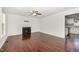 Spacious living room featuring a fireplace, hardwood floors, bright white walls, and a view into the kitchen at 40 Crepe Myrtle Ct, Angier, NC 27501