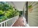 Covered front porch with white railing and decorative hanging ornaments at 40 Crepe Myrtle Ct, Angier, NC 27501