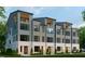 Modern townhome with gray siding, white brick, large windows, and a private balcony at 410 Chatham View Rd, Cary, NC 27511