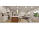 Bright kitchen with white cabinets, stainless steel appliances, island and adjacent dining area at 410 Chatham View Rd, Cary, NC 27511
